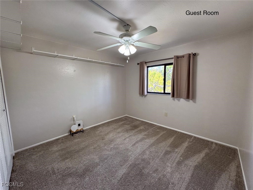 1211 Barrett Road, Unit 1106 North Fort Myers, FL 33903 - Photo 12 of 28 an empty room with windows and fan