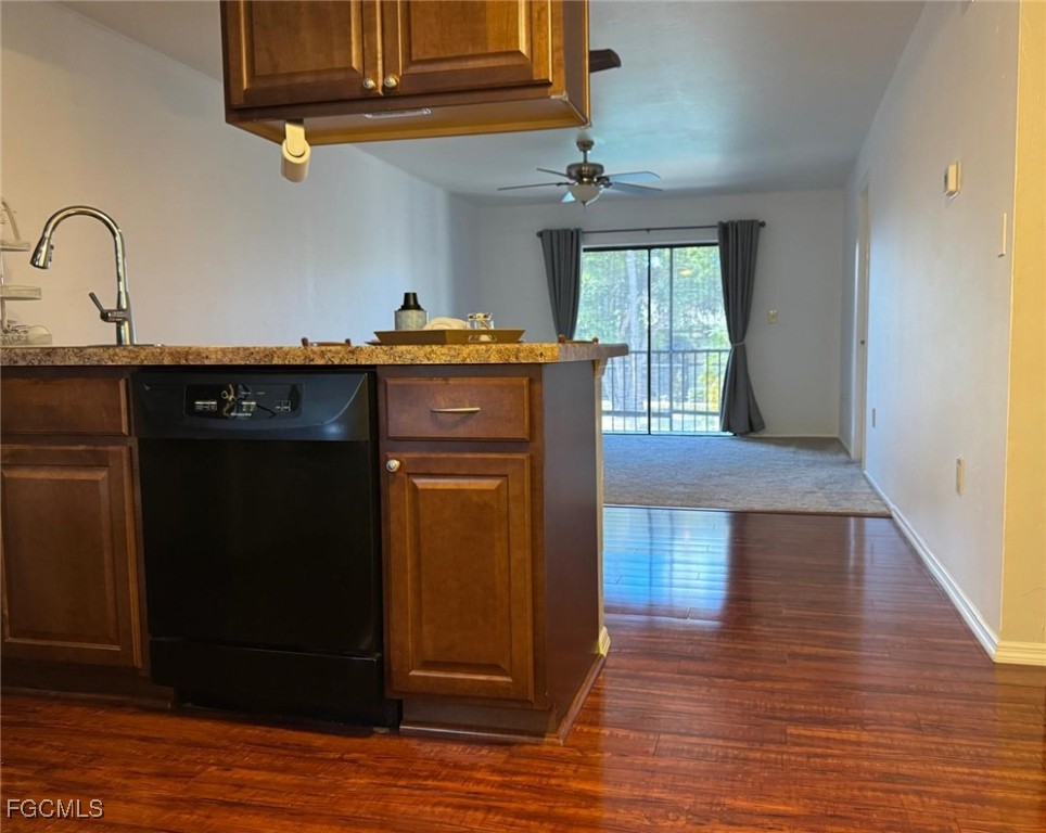 1211 Barrett Road, Unit 1106 North Fort Myers, FL 33903 - Photo 4 of 28 a kitchen with granite countertop wooden cabinets and a wooden floor