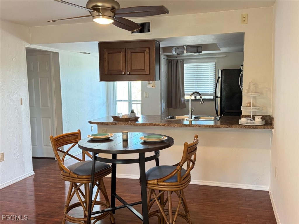 1211 Barrett Road, Unit 1106 North Fort Myers, FL 33903 - Photo 5 of 28 a dining room with furniture and window