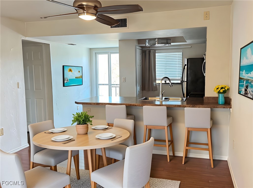 1211 Barrett Road, Unit 1106 North Fort Myers, FL 33903 - Photo 6 of 28 a view of a dining room with furniture and wooden floor