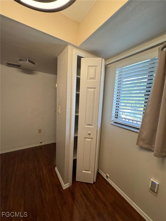 1211 Barrett Road, Unit 1106 North Fort Myers, FL 33903 - Photo 8 of 28 an empty room with wooden floor and windows