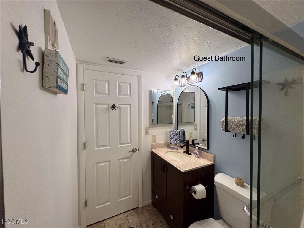 1211 Barrett Road, Unit 1106 North Fort Myers, FL 33903 - Photo 10 of 28 a bathroom with a toilet sink and mirror
