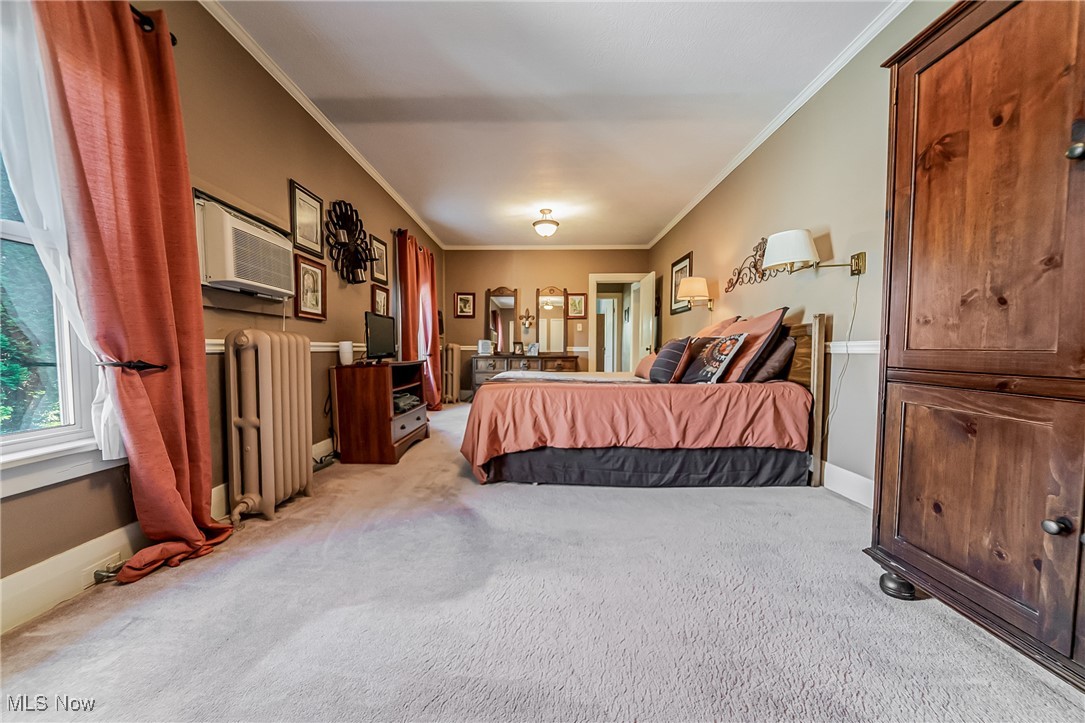 1104 Waverly Road Sandusky, OH 44870 - Photo 24 of 46 Carpeted bedroom with crown molding, radiator, and a wall unit AC