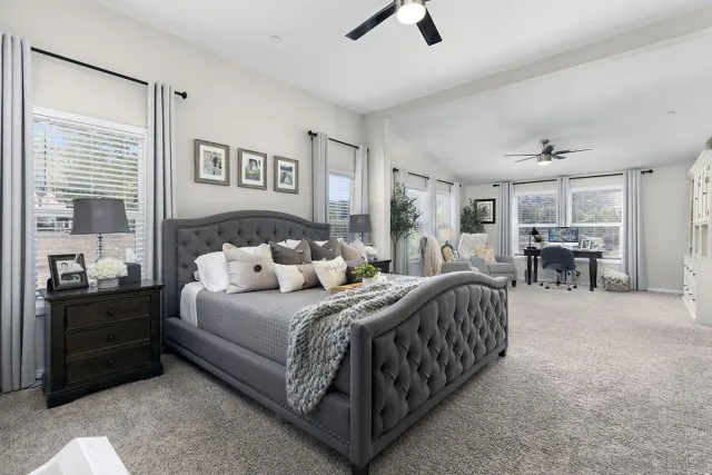 a bedroom with a bed couch and a window