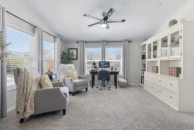 a living room with furniture and a cabinet