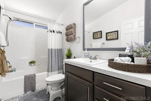 a bedroom with bed and wooden floor