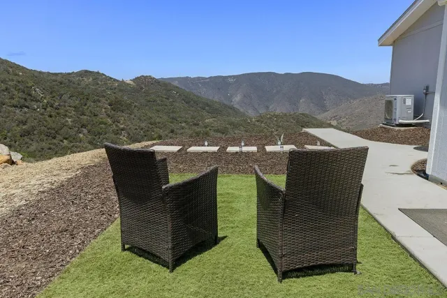 a backyard of a house with table and chairs