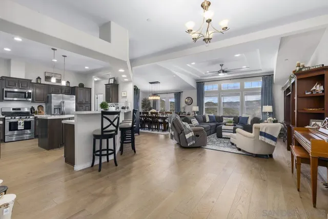 a living room with lots of furniture and kitchen view