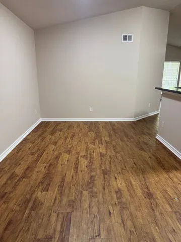 a view of wooden floor in an empty room