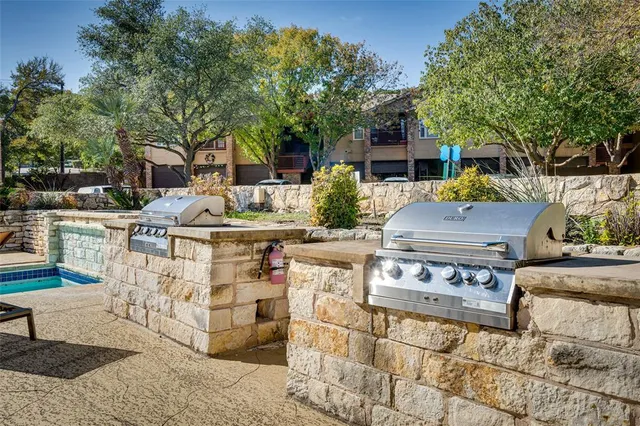 a swimming pool with outdoor seating and a garden