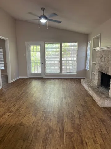 a kitchen with granite countertop a stove and a wooden floors