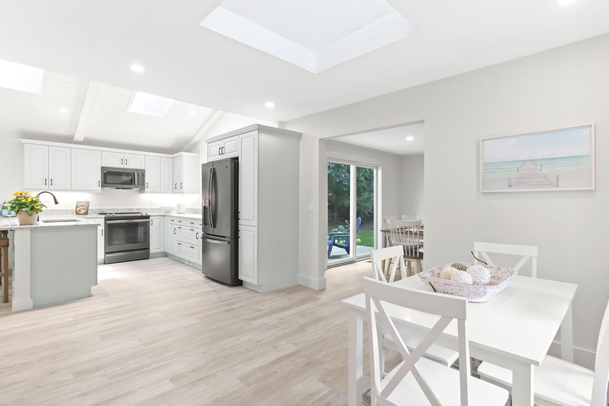 193 Northgate Road Chatham, MA 02633 - Photo 19 of 72 a kitchen with stainless steel appliances kitchen island granite countertop a refrigerator oven a sink dishwasher and white cabinets with wooden floor