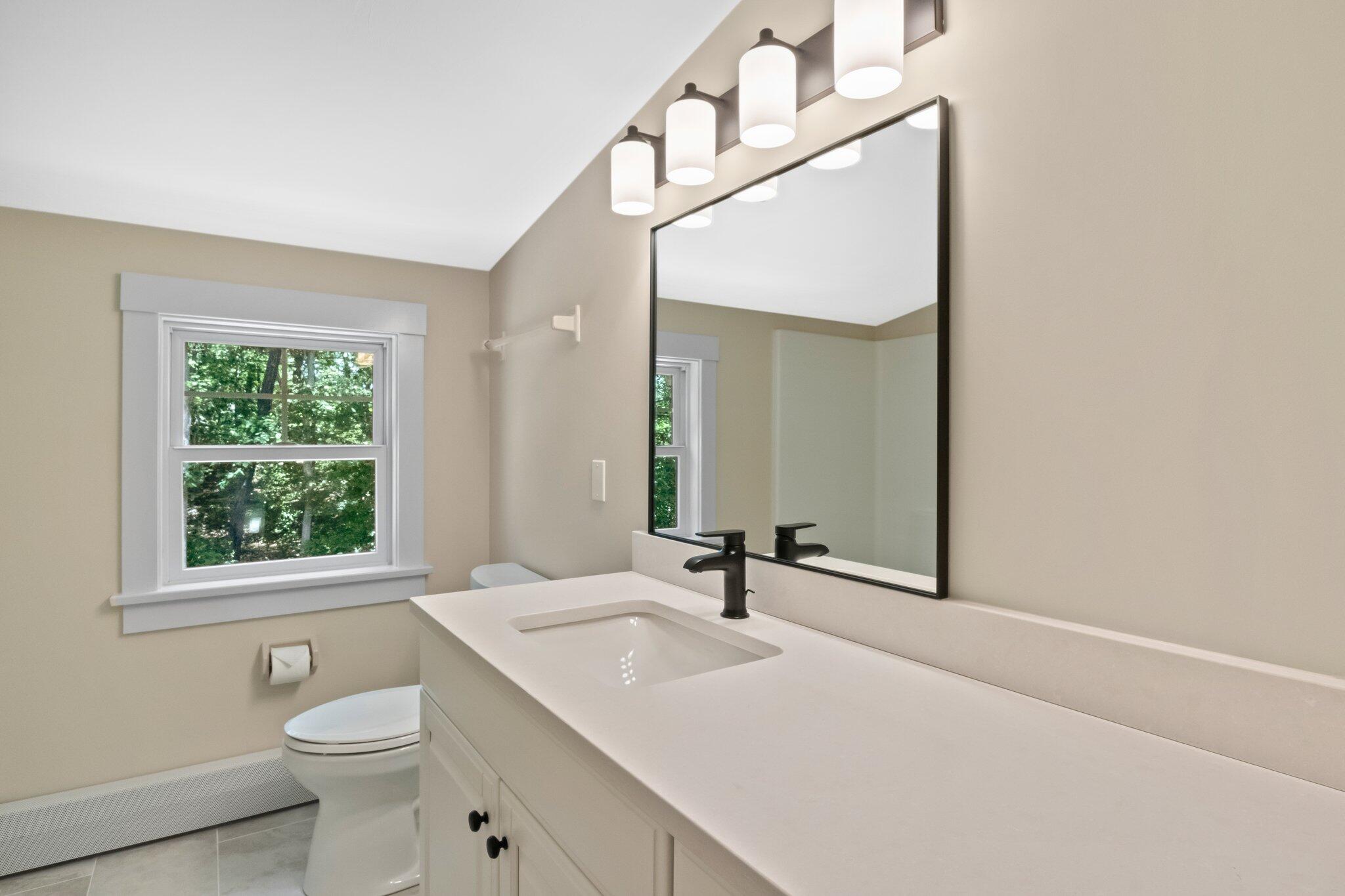 193 Northgate Road Chatham, MA 02633 - Photo 47 of 72 a bathroom with a toilet a sink a mirror and a window