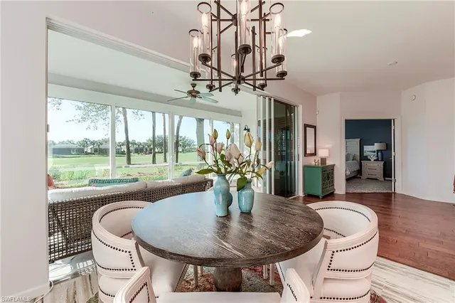 a dining room with furniture wooden floor a chandelier