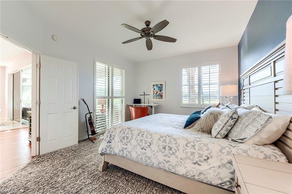 9241 Palmetto Ridge Drive, Unit 101 Estero, FL 34135 - Photo 17 of 28 a bedroom with a large bed and a window