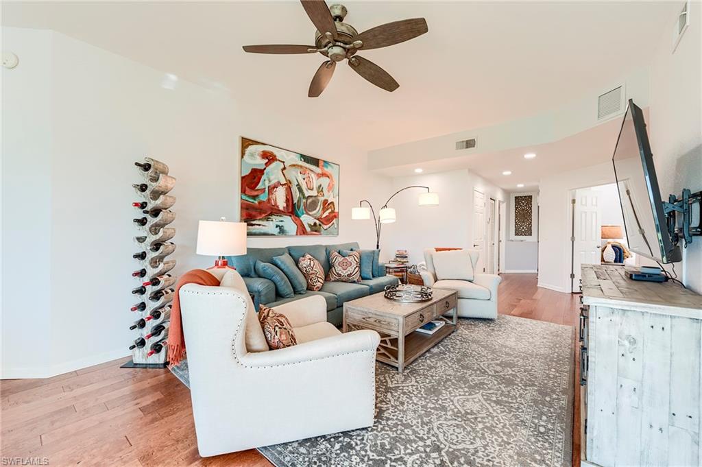 9241 Palmetto Ridge Drive, Unit 101 Estero, FL 34135 - Photo 2 of 28 a living room with furniture and a flat screen tv