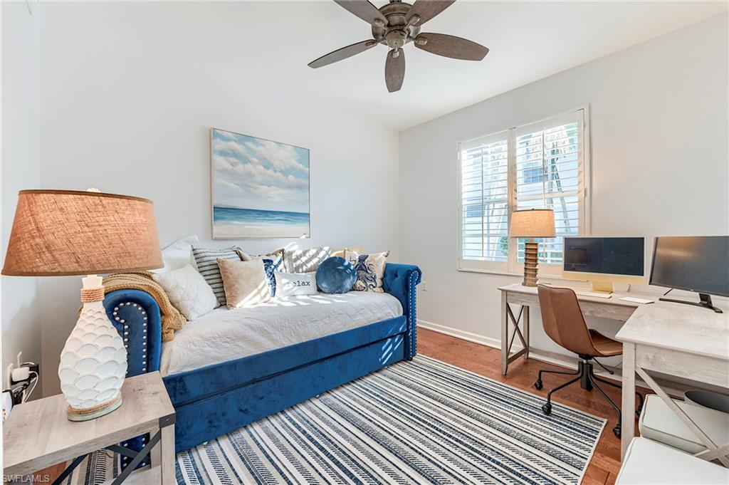 9241 Palmetto Ridge Drive, Unit 101 Estero, FL 34135 - Photo 21 of 28 a bedroom with furniture and a window