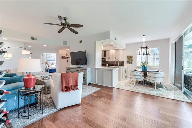 a living room with furniture and kitchen view