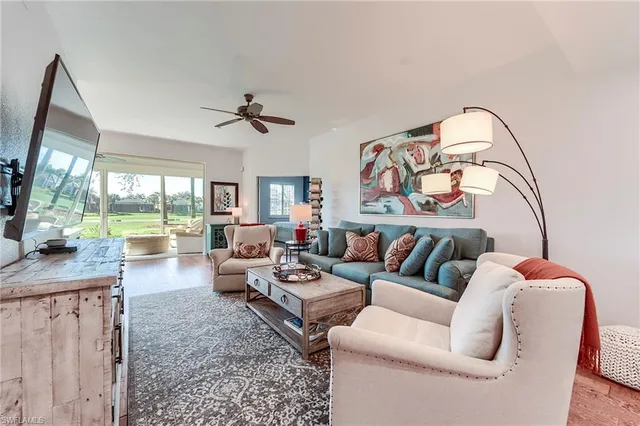 a living room with furniture fireplace and a flat screen tv