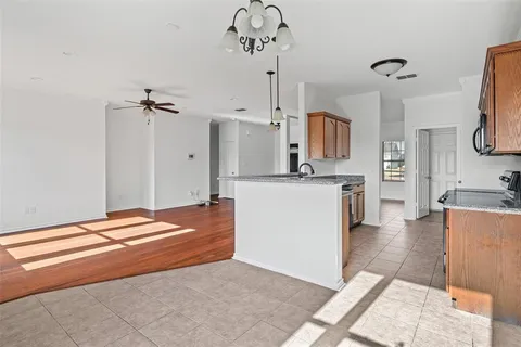 a kitchen with stainless steel appliances granite countertop a sink a stove and a refrigerator