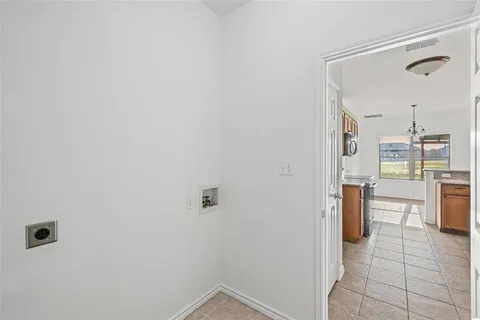 a view of a bedroom with a bed and a ceiling fan