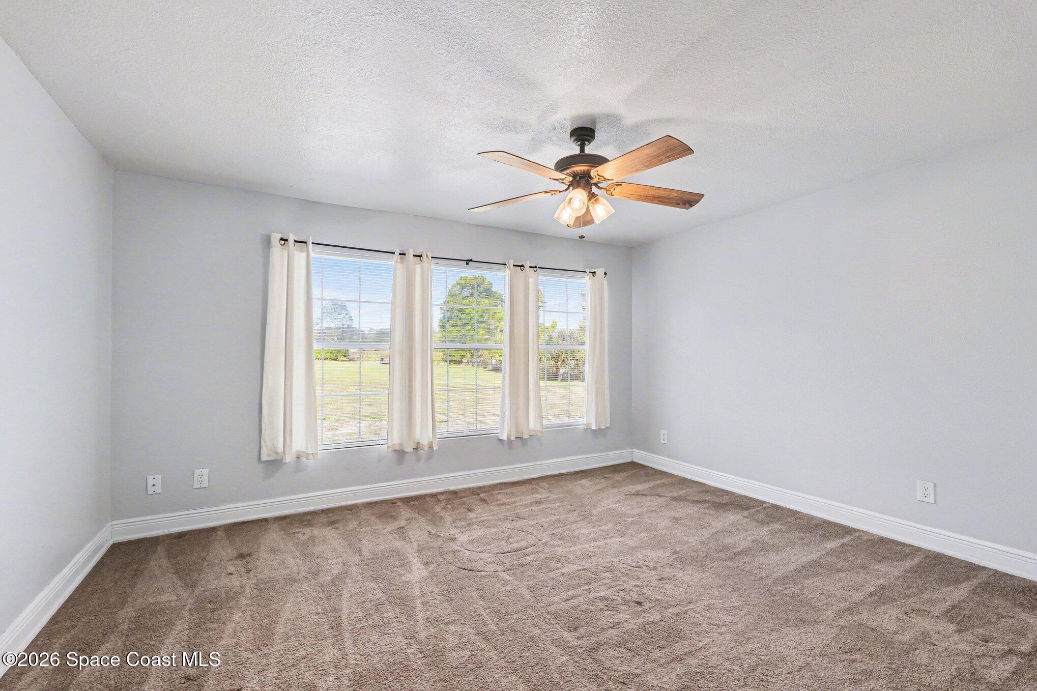4950 Blounts Ridge Road Mims, FL 32754 - Photo 7 of 40 a view of an empty room with a window