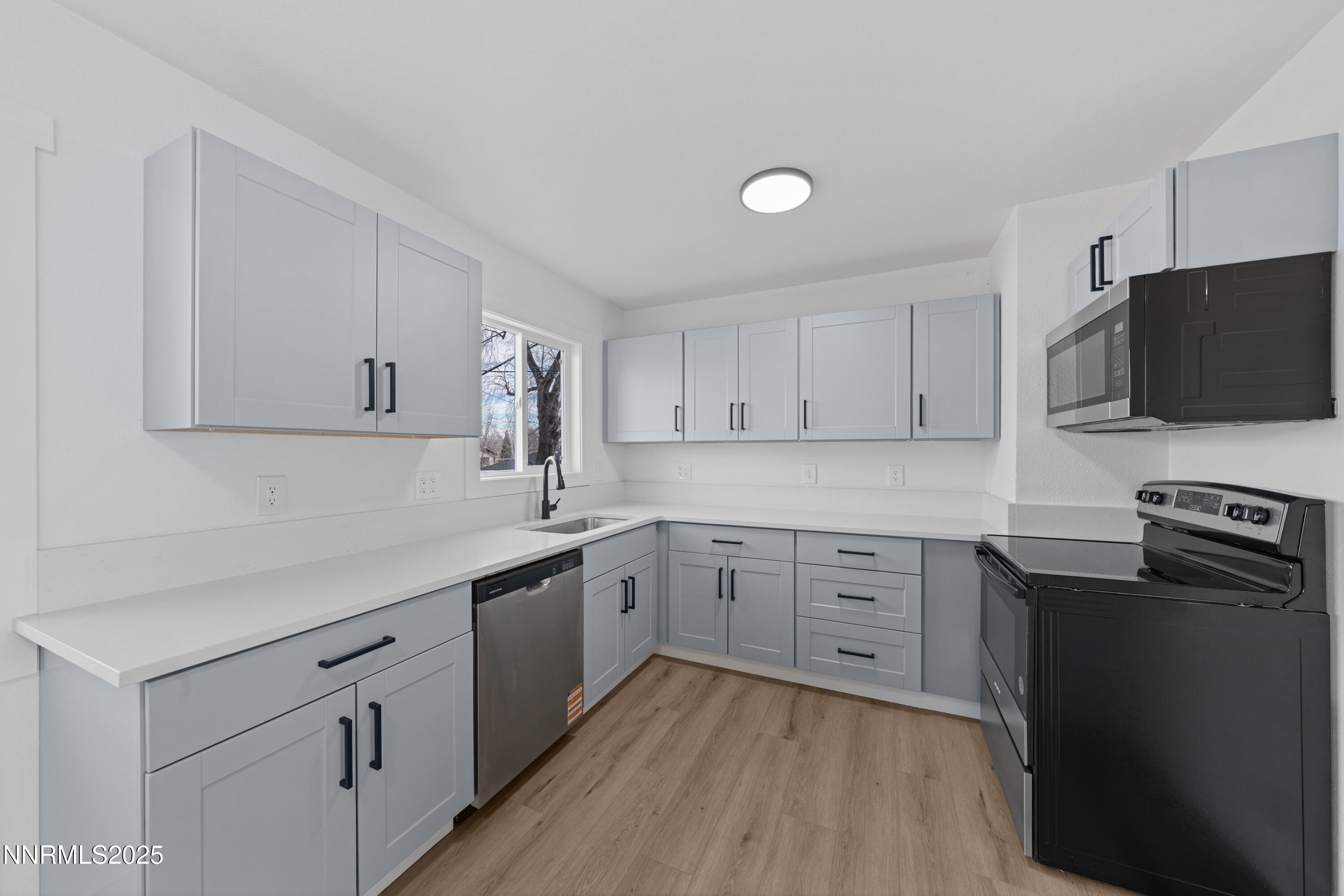 1620 Harold Drive Reno, NV 89503 - Photo 12 of 49 a kitchen with sink stove and white cabinets