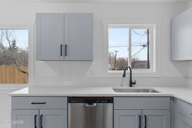 a kitchen with a sink cabinets and window