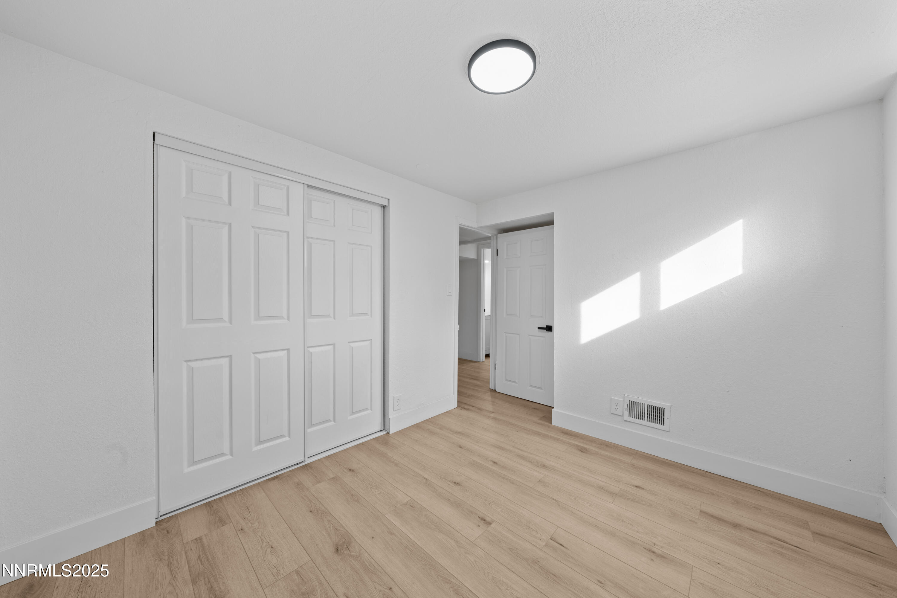 1620 Harold Drive Reno, NV 89503 - Photo 32 of 49 an empty room with wooden floor and windows