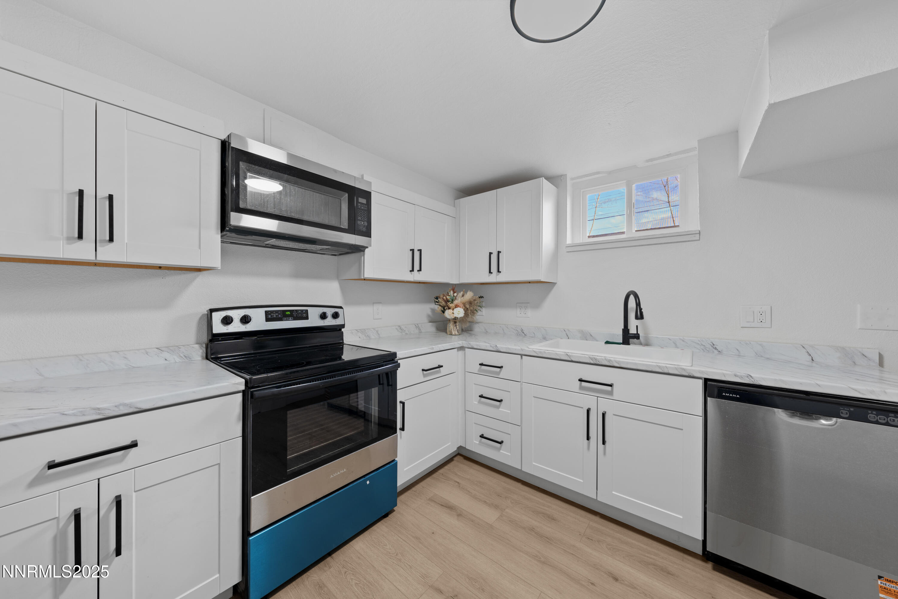 1620 Harold Drive Reno, NV 89503 - Photo 38 of 49 a kitchen with stainless steel appliances granite countertop a sink dishwasher a stove and a microwave oven with cabinets