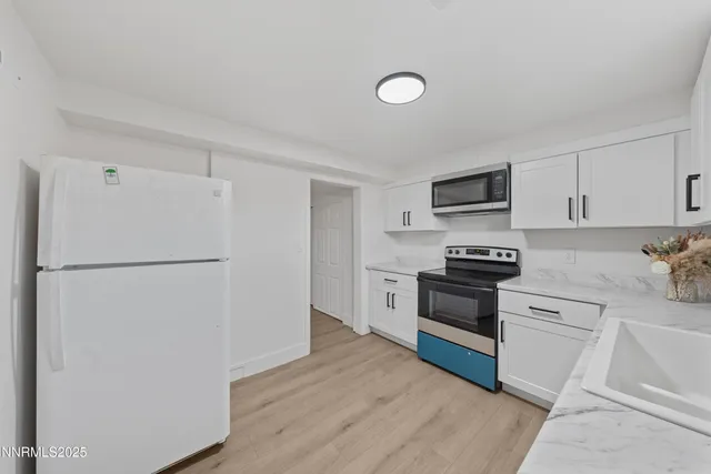 a kitchen with a refrigerator sink and stove top oven