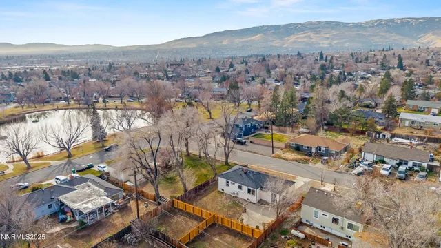 an aerial view of residential houses with city view