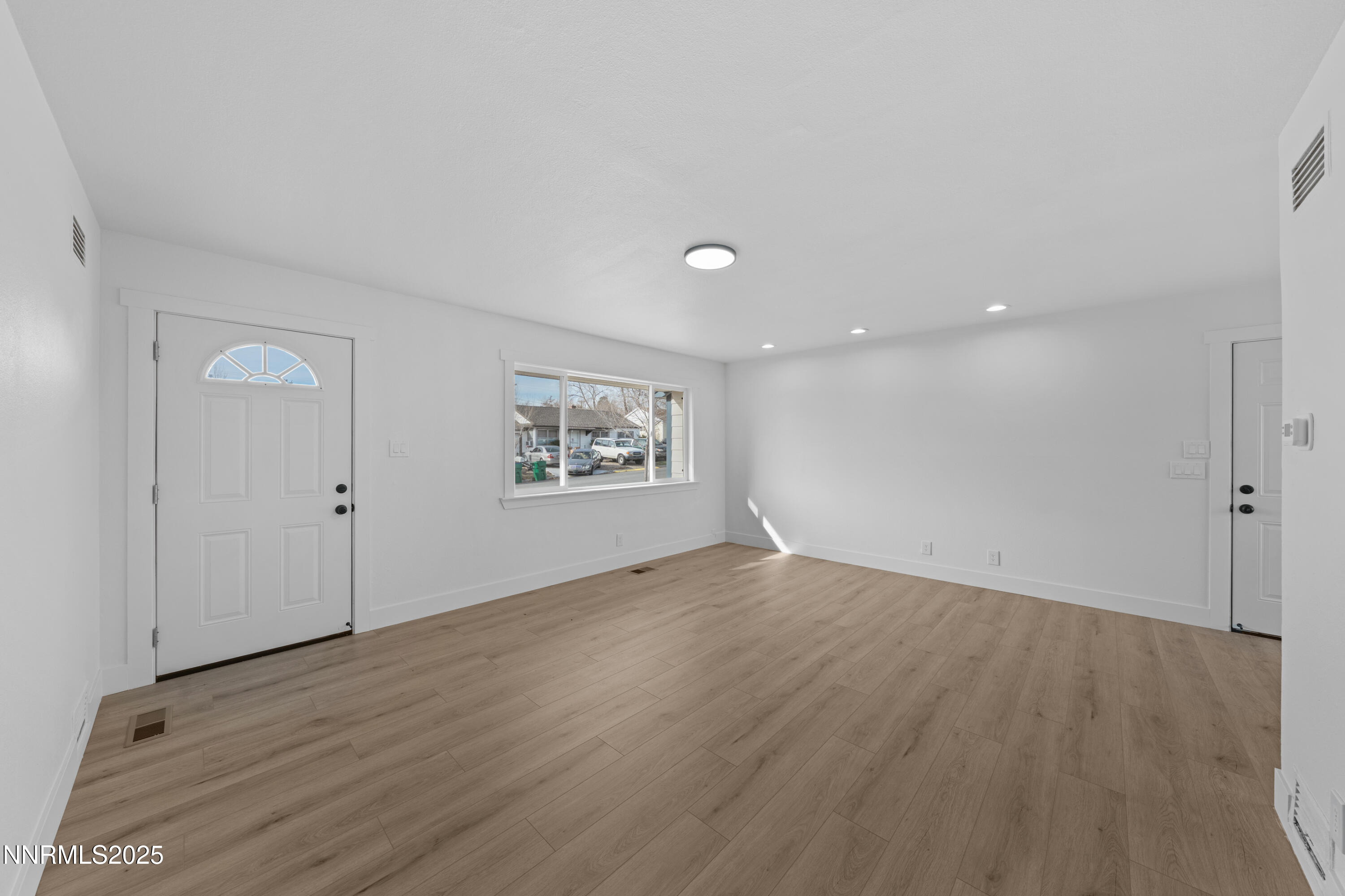 1620 Harold Drive Reno, NV 89503 - Photo 7 of 49 an empty room with wooden floor and windows