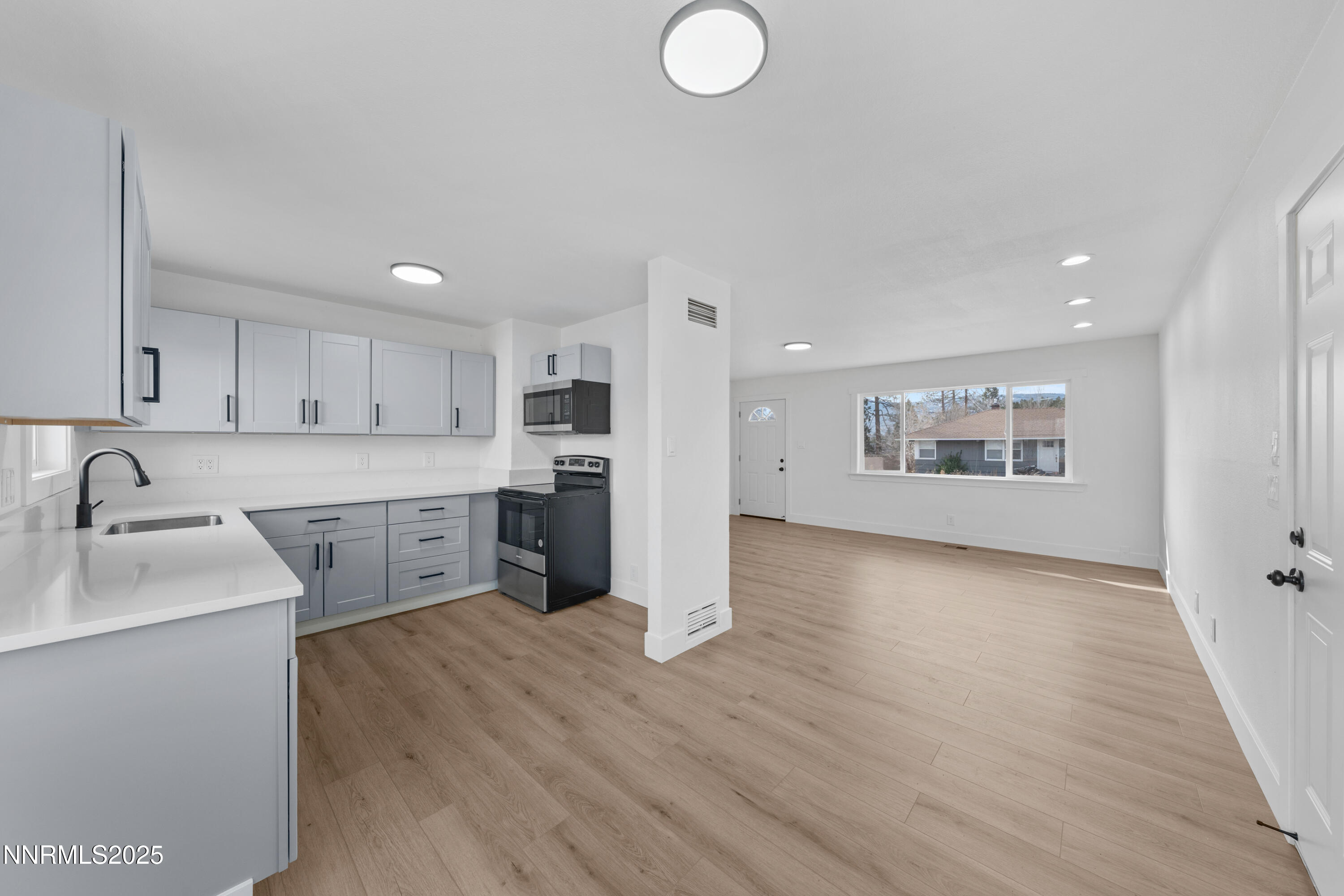 1620 Harold Drive Reno, NV 89503 - Photo 9 of 49 a kitchen with stainless steel appliances granite countertop a sink cabinets and wooden floor