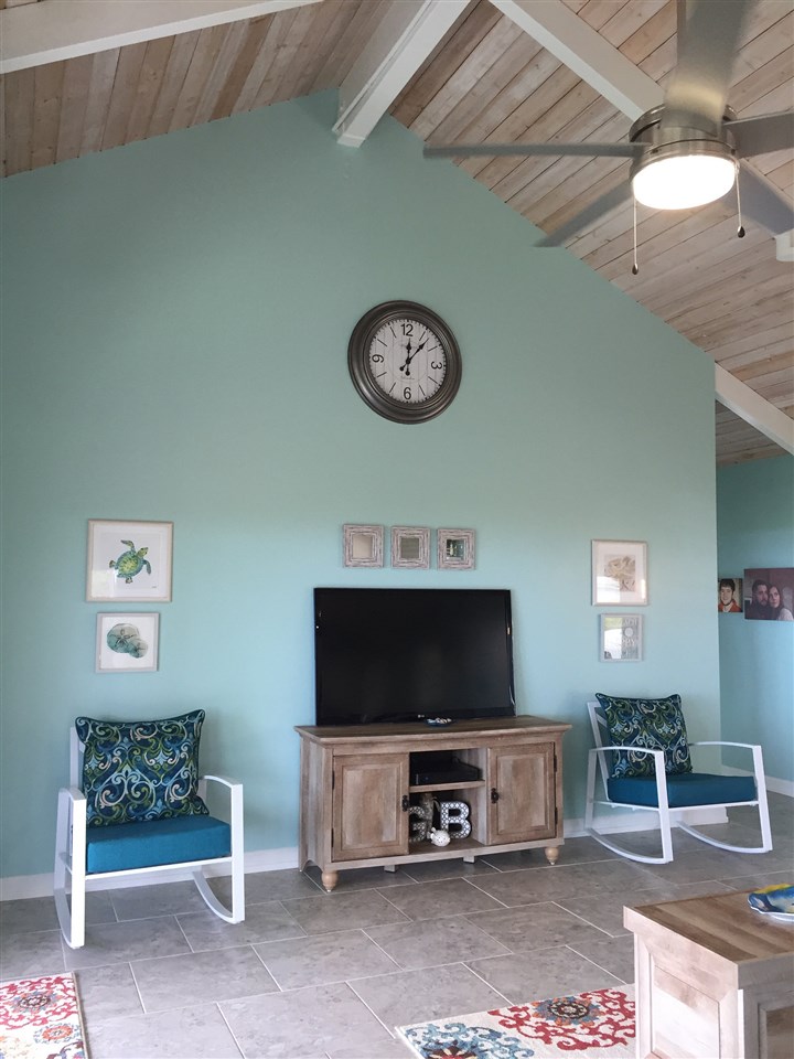 300 Hanauana Road Haiku, HI 96708 - Photo 16 of 30 a living room with furniture a flat screen tv and a table