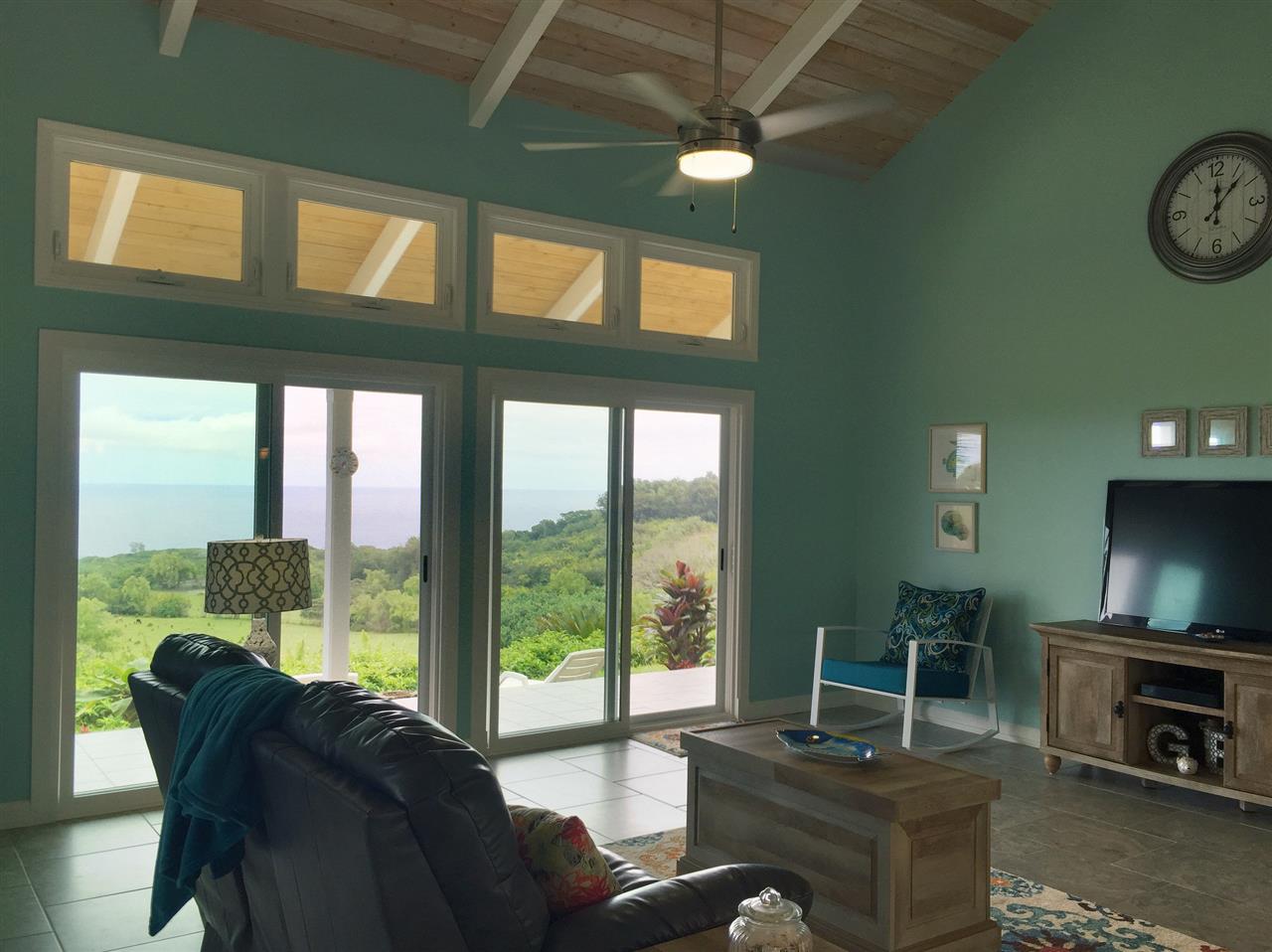 300 Hanauana Road Haiku, HI 96708 - Photo 17 of 30 a living room with furniture a flat screen tv and a large window