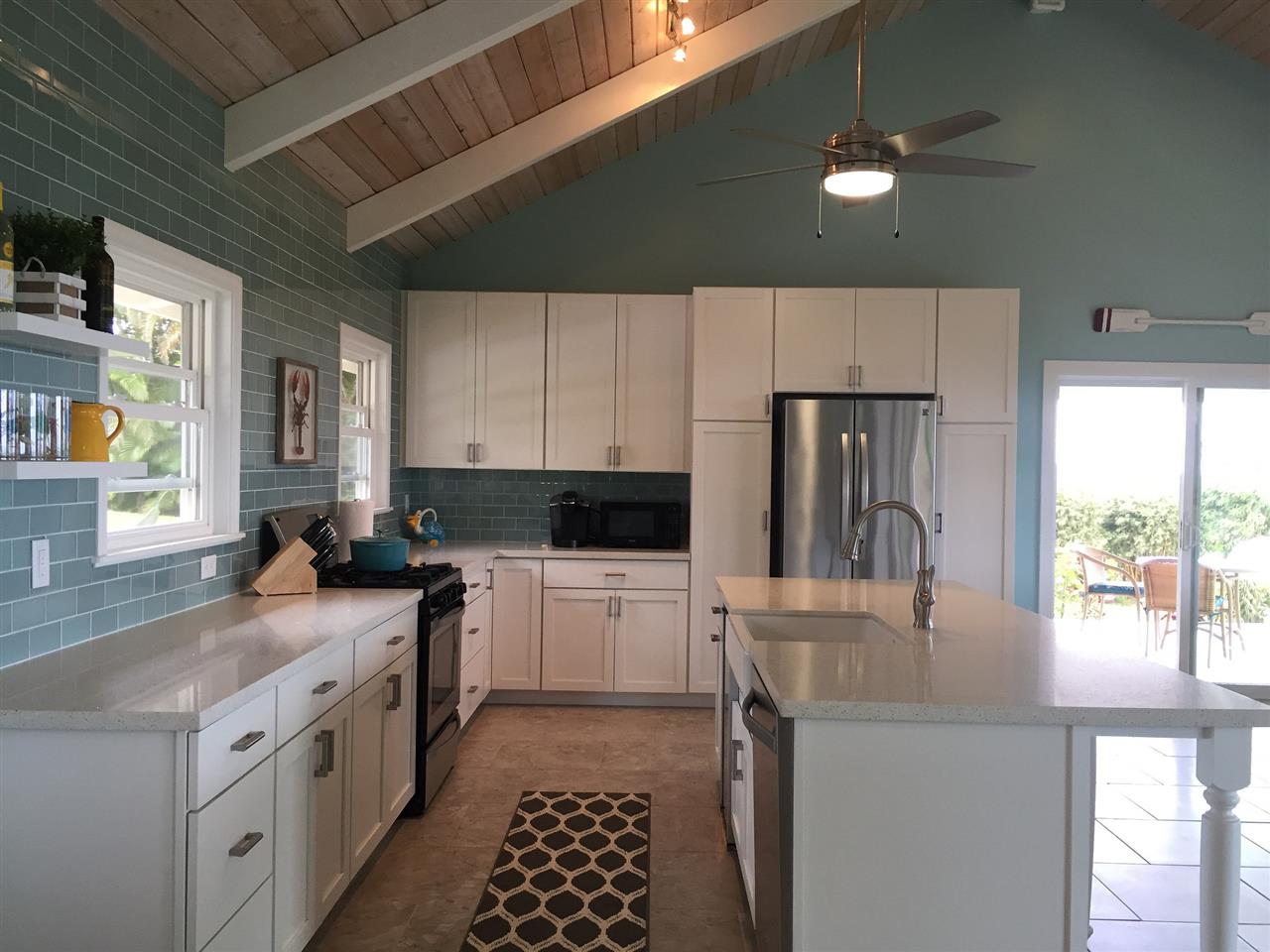 300 Hanauana Road Haiku, HI 96708 - Photo 6 of 30 a kitchen with a stove a sink and a refrigerator