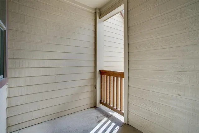 a view of a house with brick walls and a yard
