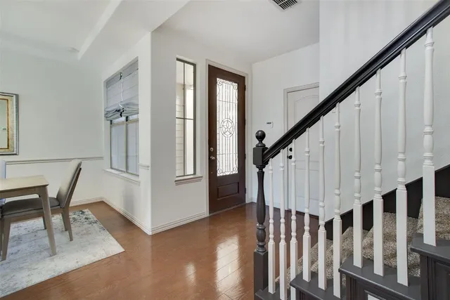 a view of entryway with wooden floor and stairs
