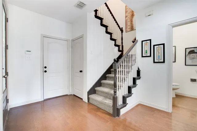 a view of entryway and hall with wooden floor