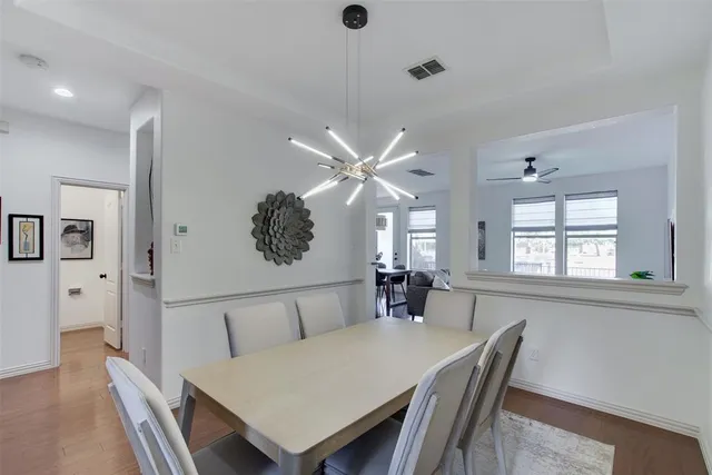 a view of a a dining room with furniture window and wooden floor