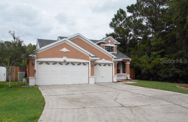 4755 Ridgemoor Circle Palm Harbor, FL 34685 - Photo 1 of 1 a view of house with a yard and garage