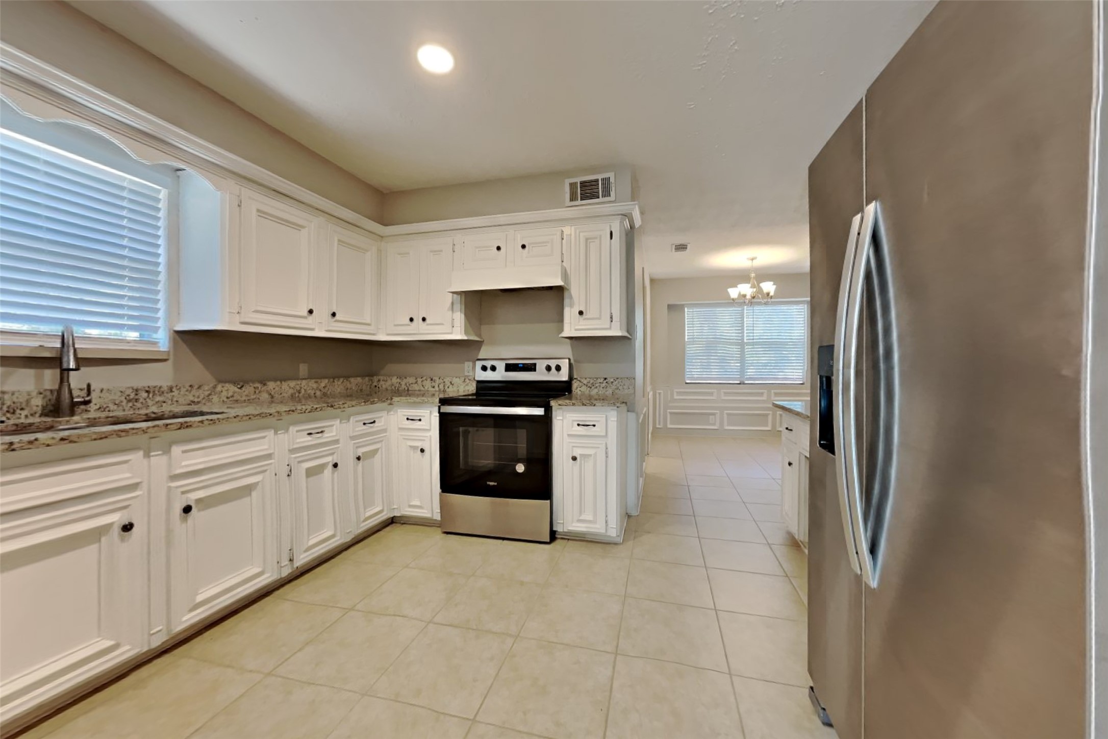 19022 White Candle Drive Spring, TX 77388 - Photo 5 of 22 a kitchen with stainless steel appliances granite countertop a refrigerator sink and cabinets