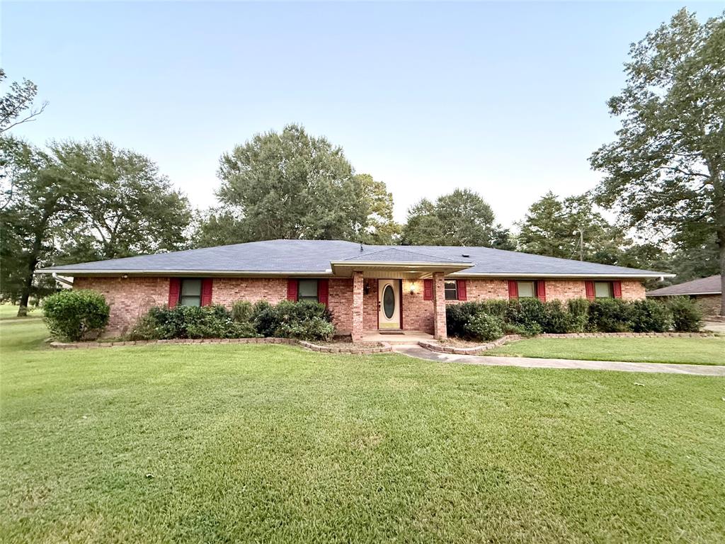 Single story home featuring a front yard and brick siding