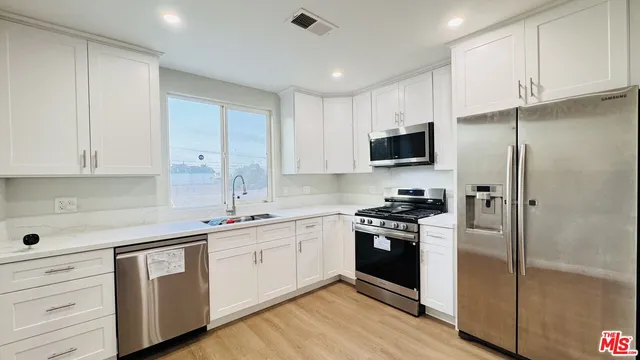 a kitchen with a sink stove and refrigerator