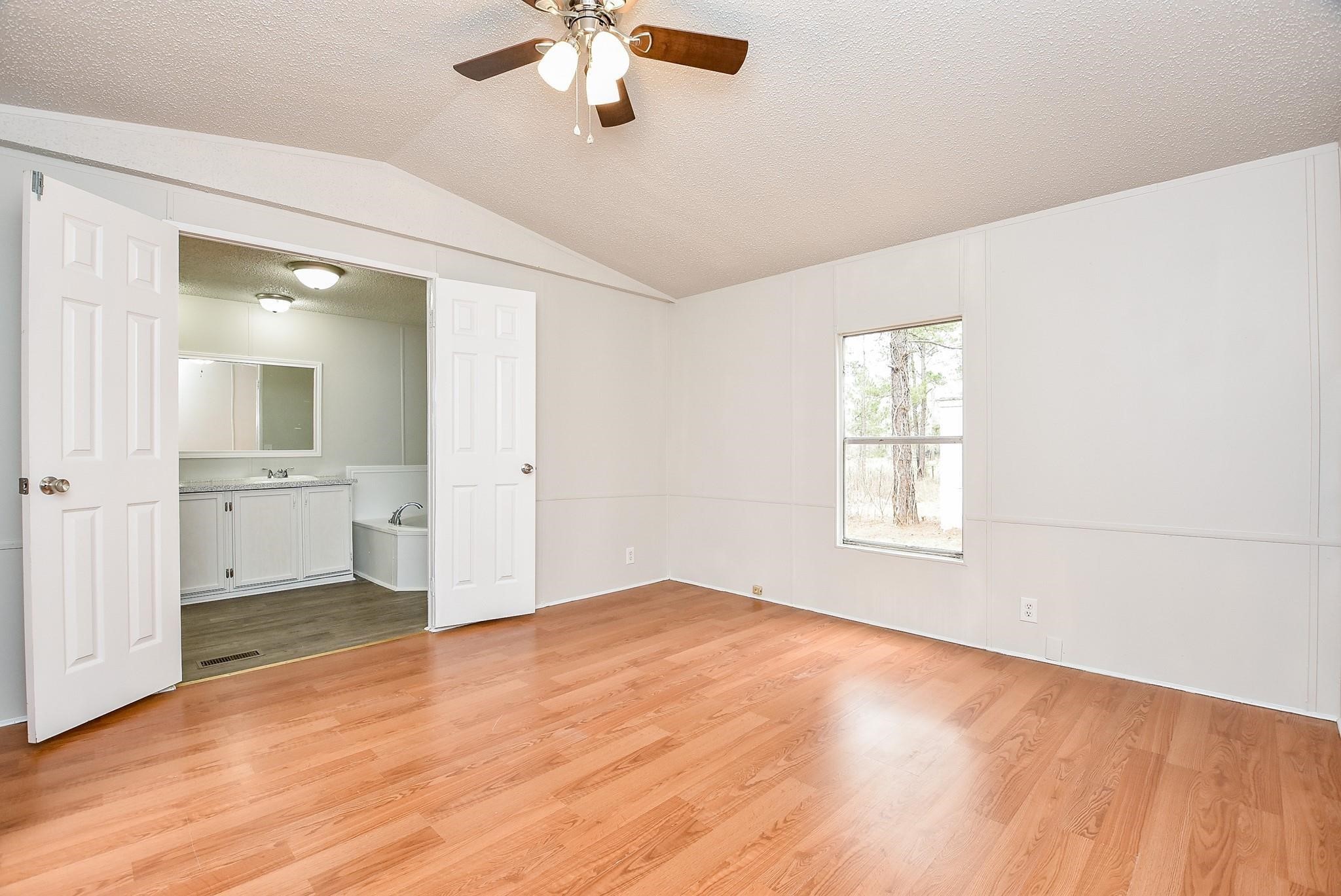 12842 Roy Harris Loop Conroe, TX 77306 - Photo 28 of 36 a view of an empty room with a window