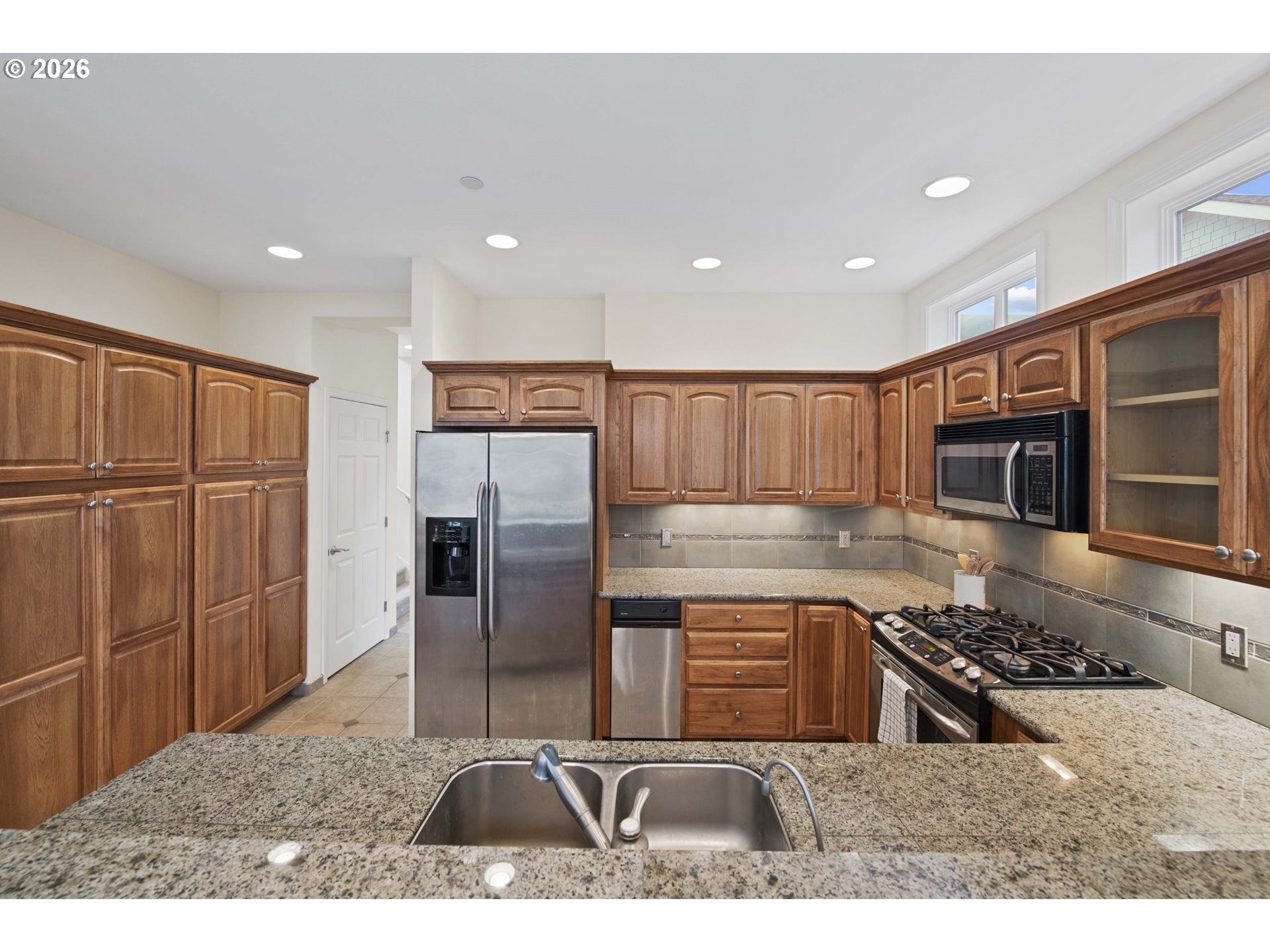 230 Round House Road Astoria, OR 97103 - Photo 15 of 43 a kitchen with stainless steel appliances granite countertop a refrigerator and a sink
