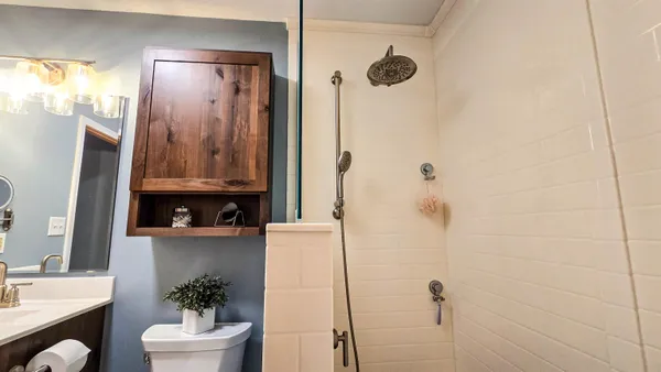 a view of a workspace with furniture and a window