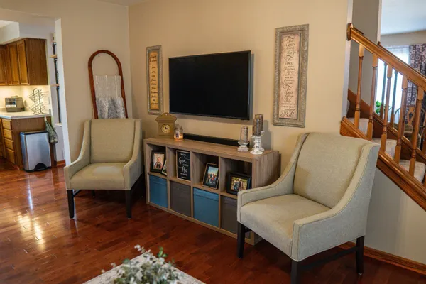 a bedroom with a bed and a painting on the wall