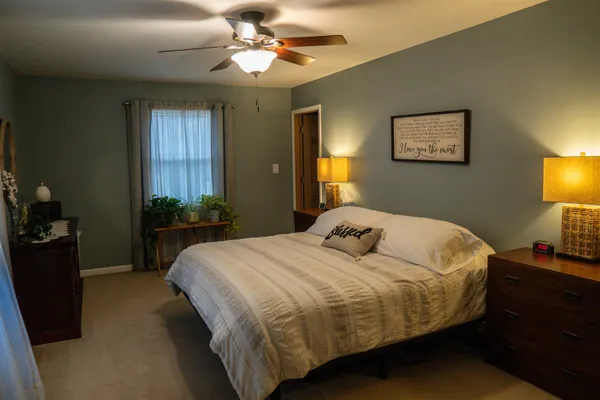 a view of a workspace with furniture and a bookshelf